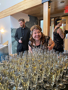Lady posing by the champagne glasses at the gala