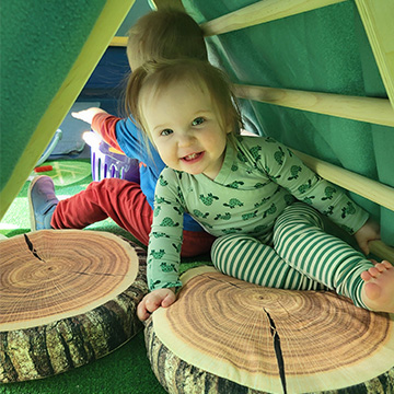 two students playing in a tent